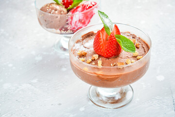 Sweet chocolate and strawberry ice cream in glasses. Top view. Free space for text.