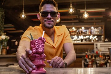 Latin Barman preparing alcoholic cocktail 
