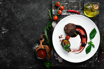 Grilled veal medallions with grilled vegetables. Top view. Free space for text.