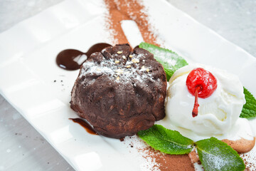 Chocolate fondant cake with ice cream and mint. Top view. Free space for text.