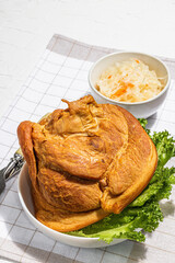 Oktoberfest smoked pork knuckle eisbein with fermented sour cabbage. German festival food