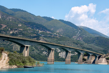 Road Bridge Over Lake against mountain range