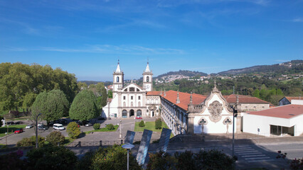 Santo Tirso, Portugal, April 16, 2022: Aerial view of the Abade Pedrosa Municipal Museum and the Monastery of St. Benedict (Sao Bento) in the city of Santo Tirso, with the Ave River in the background.
