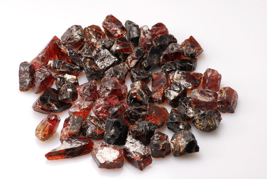 Raw rough pyrope garnet crystals lot from South Africa. Unpolished raw gemstones ready for faceting or using in jewelry making. White background. Unheated, untreated semiprecious gems. Gemology theme.