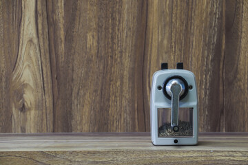 stapler placed on wooden table with copy space for vintage style wood grain background design