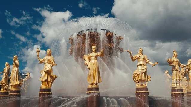 Fountain Friendship of peoples, golden female statue figures are symbols of USSR nations. Soviet Union era complex VDNKh, All-Russian exhibition center VDNH, recreational city park in Moscow, Russia. 