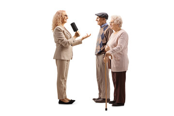 Female reporter interviewing an elderly couple