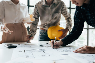 Close up of hands working brainstorming and measuring for cost estimating on paperworks and floor...