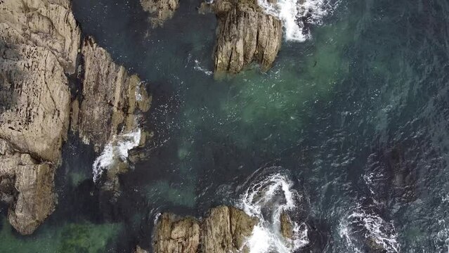 Beautiful waters of the Atlantic Ocean. Seascape from a height. Small waves on the Celtic Sea. Seaside cliffs.