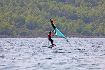 Windsurfer in the sea, man on windsurfing conquer the waves