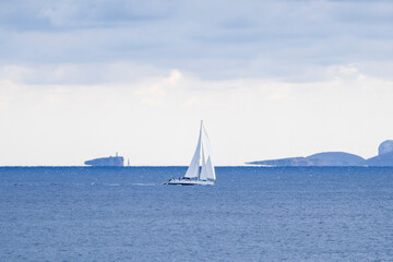 Fototapeta premium Sailing in front of the Cabrera Maritime National Park, Sa Rapita, Majorca, Balearic Islands, Spain