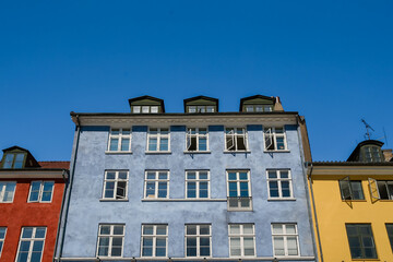 Fototapeta na wymiar Copenhagen, Denmark - July 10, 2018: Buildings along the waterfront of Copenhagen 