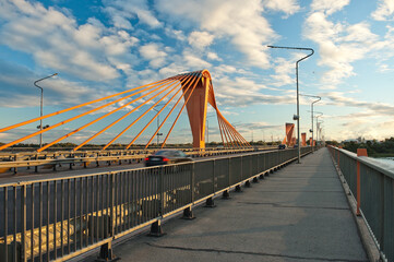 Fototapeta na wymiar cable-stayed bridge in Riga, in the photo south bridge in the evening against the background of blue sky and clouds