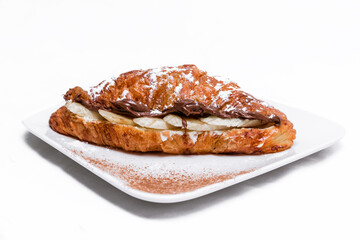Croissant with chocolate butter and banana isolated on a white background.