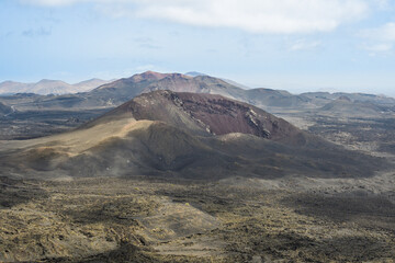Volcanoes, black lava and islets of Lanzarote seen from Caldera Blanca