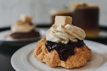 Dessert set of scones and americano coffee for couple served in cafe.