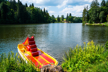 Germany, Pedal boat at ebnisee lake in beautiful swabian forest near kaiserbach and welzheim in...