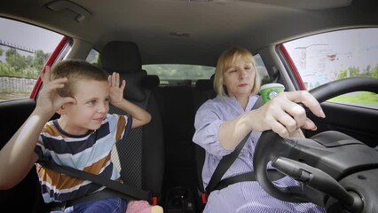Grandson gets in the way and annoys his grandmother in the car