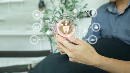 A young man order for online shopping via mobile phone. Hologram screen icon of online shopping and technology concept