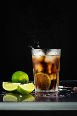 Cuba libre cocktail with lime.