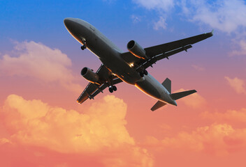 airplane in beautiful colorful dramatic sky with cloud, handsome sunset, Dawn, concept flight in...
