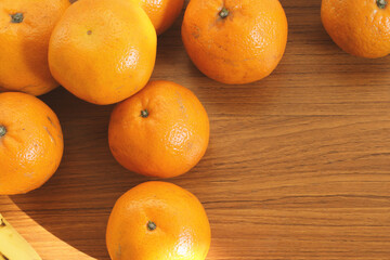 Tangerines on a wooden table. View from above.