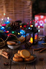 Christmas cookies with festive decoration in an evening cozy setting. Vertical photo