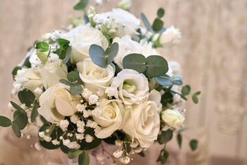 A beautiful wedding bouquet of white roses. Preparation for the wedding.