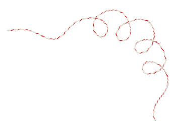 Curled white and red Christmas wrapping rope in a corner arrangement isolated on white
