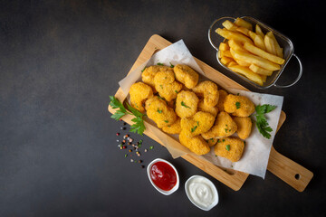 Delicious chicken nuggets and chips.