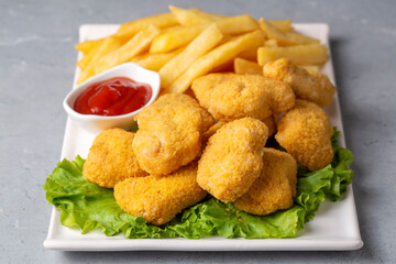 Delicious chicken nuggets and chips.