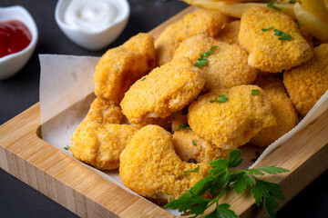Delicious chicken nuggets and chips.