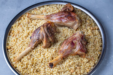 Turkish foods; lamb shank tandoori on bulgur wheat rice (Turkish name; bulgur bugday pilavi kuzu incik tandir)