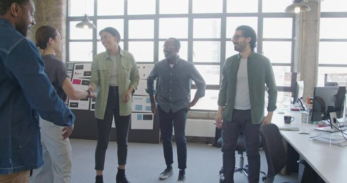 Business People Welcome Back Female Colleague in Office