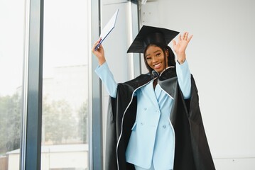 Happy beautiful black african american girl with hat graduates