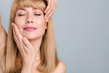 Fototapeta premium Cropped view portrait of attractive dreamy groomed woman massaging soft skin modern copy space ad isolated on grey pastel color background