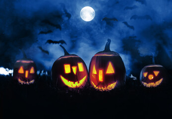 Halloween pumpkins in a misty night scene with smoke. 