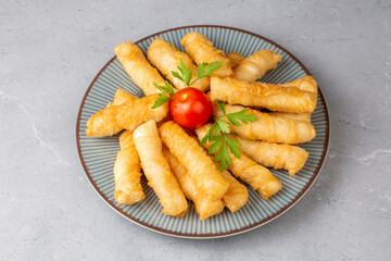 Fried pastry wrapped in cheese in phyllo. Pie in the form of a roll. Turkish name; Kalem borek - sigara boregi