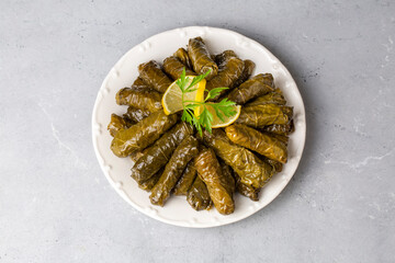 Delicious dolma (sarma) stuffed grape leaves rice. Lebanese dolma sarma on plate. Lebanon turkish greek middle eastern cuisine. (Turkish name; Yaprak sarma)
