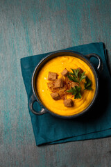 Pumpkin puree with crackers and parsley