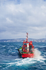 Tugboat - Rescue red vessel on a cruise at sea