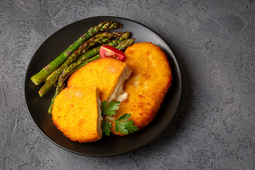 Cordon bleu served with asparagus