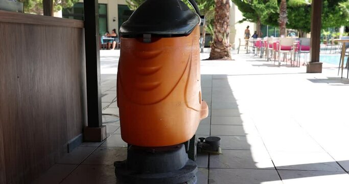 Road sweeper cleans paths in park or hotel