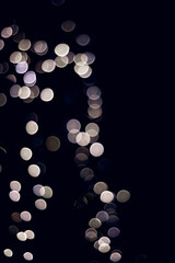 Colorful abstract bokeh made from Christmas lights on black isolated background. Holiday concept, blur bokeh, overlay for your images.
