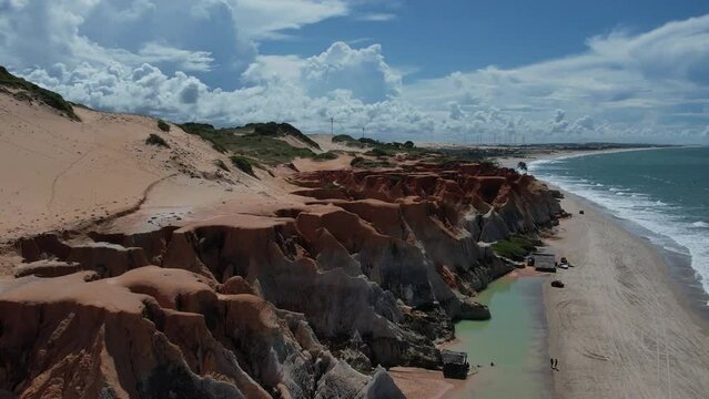 paragliding flight through the mountains, rocks and beach in Morro Branco in Ceará, Brazil