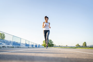 Fototapeta na wymiar one woman run on stadium running track training