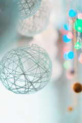 White Christmas balls with blurred background with garlands with bokeh effect