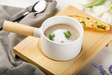 Ideal mushroom sup with garlic bread served in a dish isolated on table side view of arabian soup