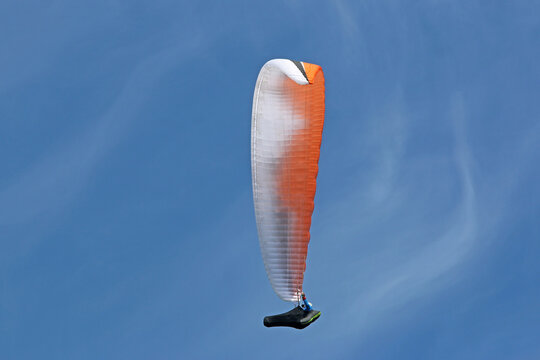 Paraglider in a blue sky	