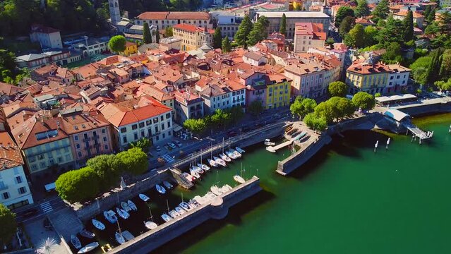 Aerial view of Lake Como. city ​​center. A local ferry arrives in the city. Bell tower. Tourism and romance. Mountains around the lake. Red roofs. Green Planet. Sailing yacht. Italy, Bellano, 09.2022